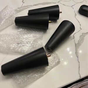 4 thick black wood legs for furniture.